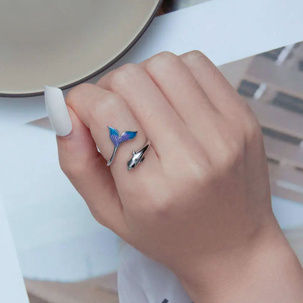 Model wearing a Rainbow Dolphin Ring on index finger